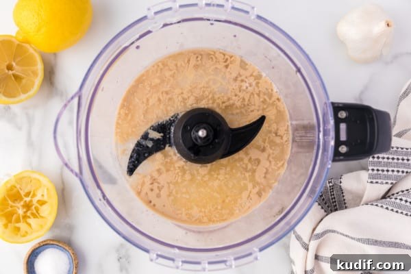 Tahini ingredients blended inside a food processor.