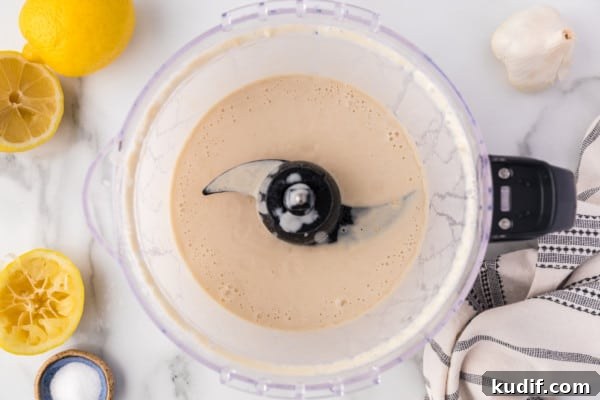 Blended tahini sauce in a food processor.