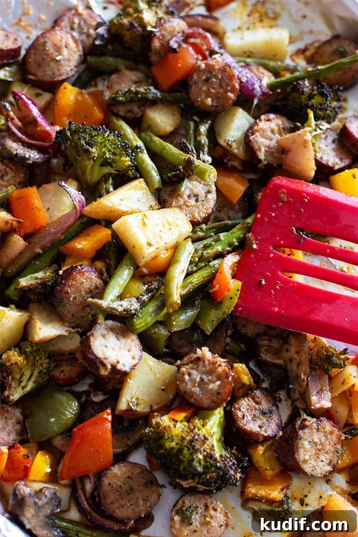 Sheet Pan Sausage with Roasted Vegetables Recipe 2 Cooked Asparagus, potatoes, broccoli, sausage and Smoked Sausage in a sheet pan.