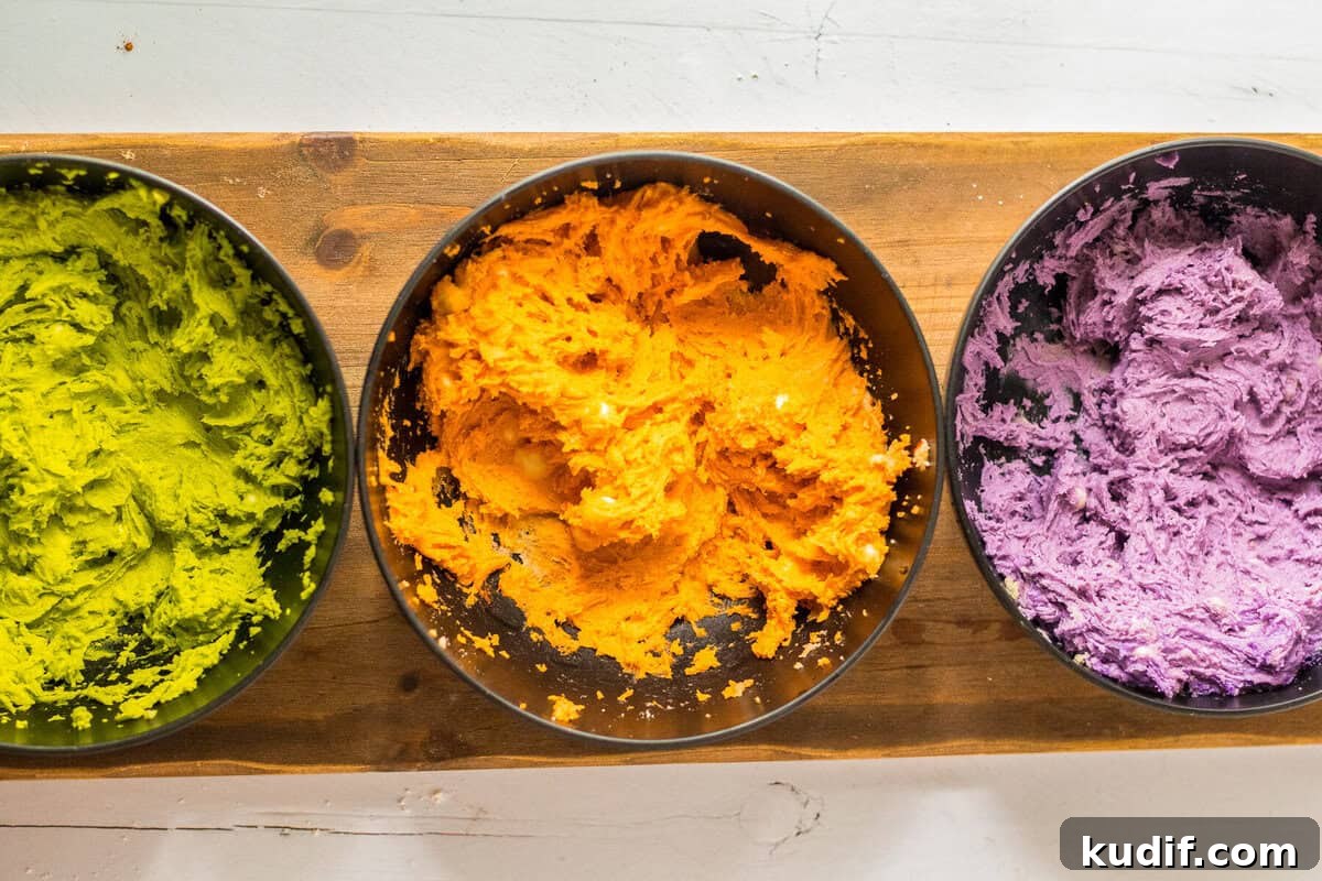 Spooky Halloween Sprinkle Cookies Recipe for Party Treats 6 Cookie dough separated into bowls, each dyed a different color (green, orange, purple).