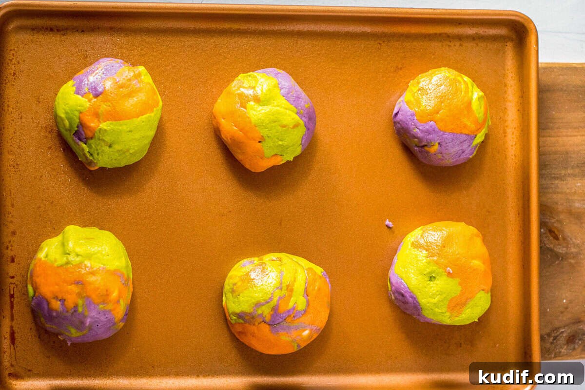 Spooky Halloween Sprinkle Cookies Recipe for Party Treats 7 Colorful marbled Halloween cookie dough on a baking tray.