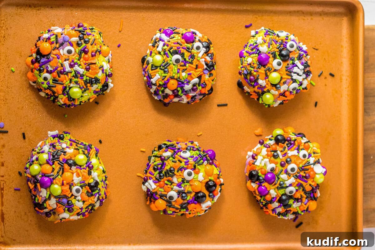 Spooky Halloween Sprinkle Cookies Recipe for Party Treats 8 Baked Halloween sprinkle cookies coated in candies.
