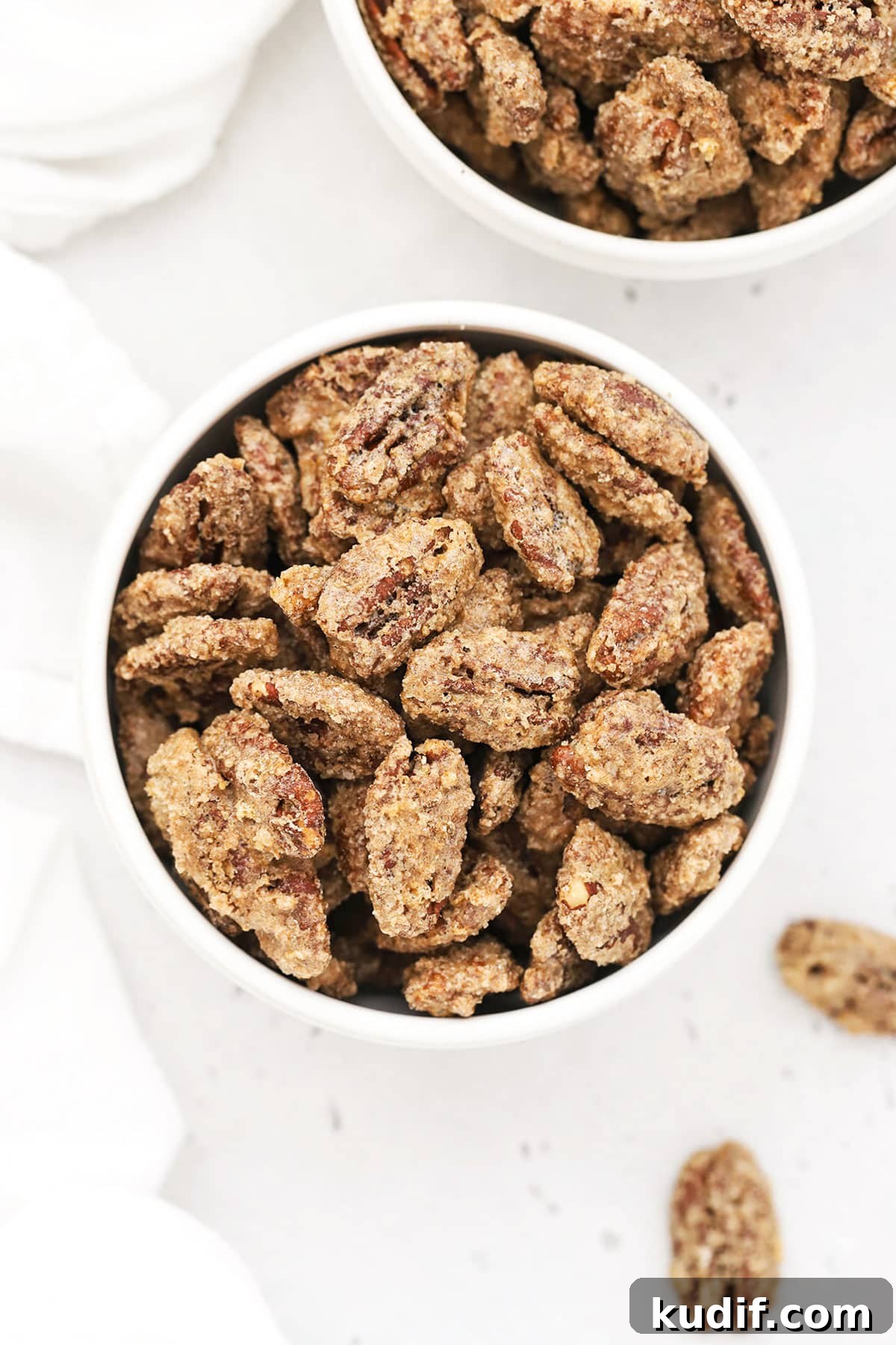 white bowls of old-fashioned cinnamon pecans