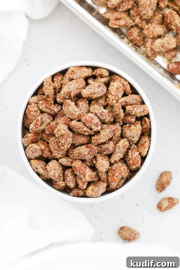 Overhead view of cinnamon almonds in a white bowl