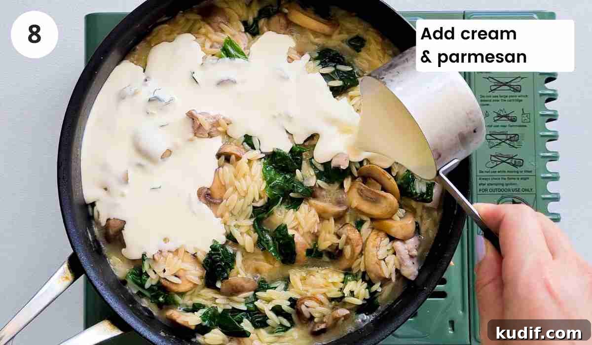 Creamy Chicken and Orzo Skillet Recipe 11 Heavy cream being poured into a pan of pasta with caption