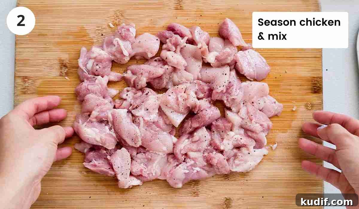 Creamy Chicken and Orzo Skillet Recipe 5 seasoned cut up chicken thighs on a cutting board with caption