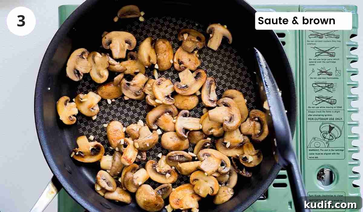Creamy Chicken and Orzo Skillet Recipe 6 Golden sauteed mushrooms in a frying pan with caption