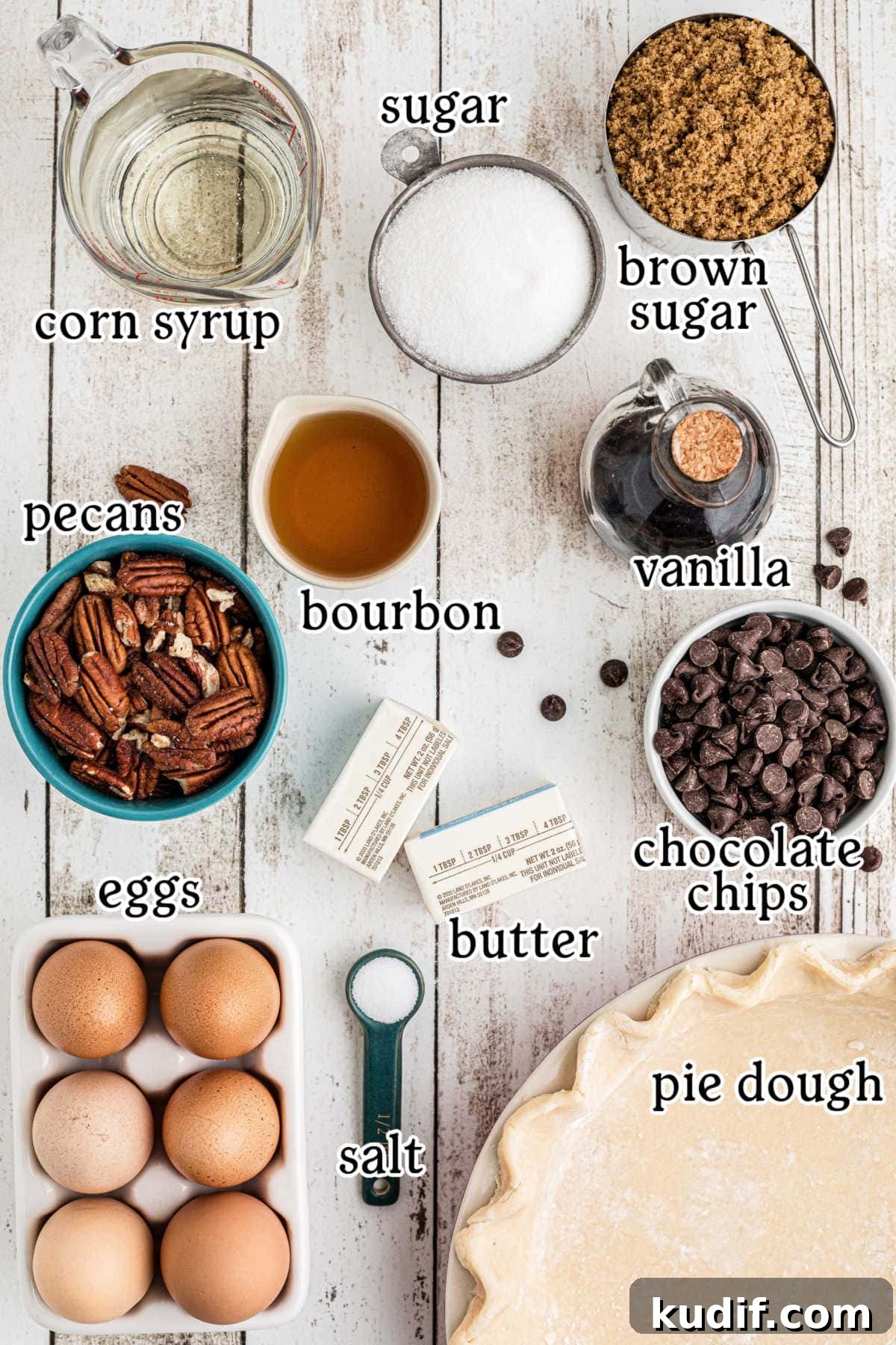 Decadent Chocolate Bourbon Pecan Pie Recipe 3 An overhead shot with text overlay of raw ingredients for chocolate bourbon pecan pie, including: corn syrup, sugar, vanilla, bourbon, pecans, eggs, chocolate chips, butter, and pie dough in various small bowls or measuring containers.