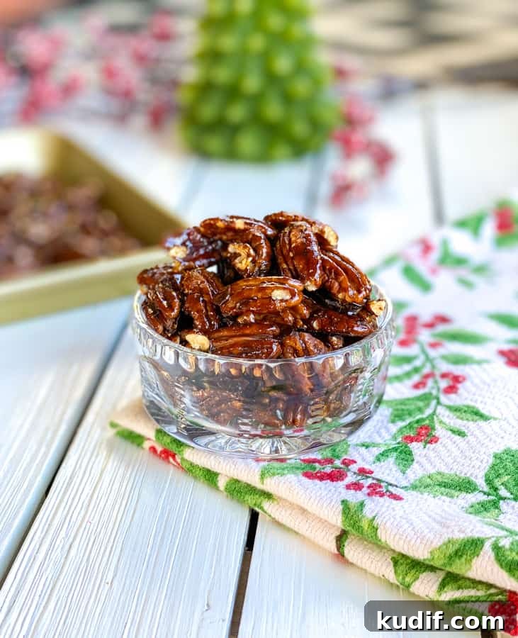 Brown Sugar Candied Pecans: Sweet & Crunchy Snack Recipe 5 Shiny candied pecans in glass bowl on table.
