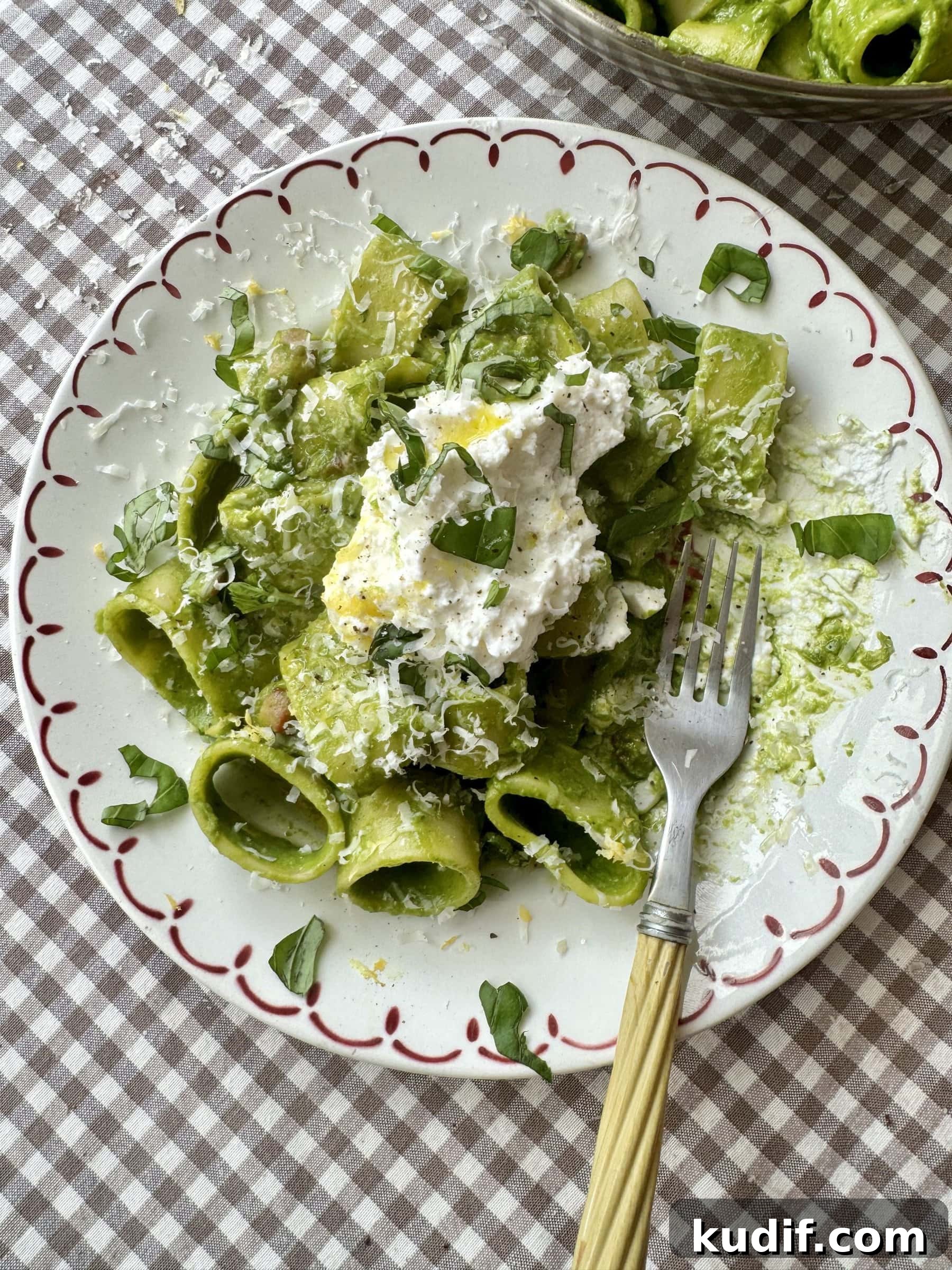 Creamy Spinach & Herb Pasta in Green Sauce 2 pasta in green sauce on a plate topped with cheese