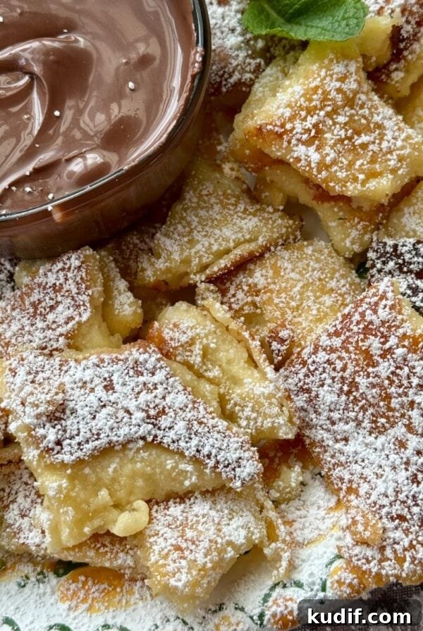 Creamy Spinach & Herb Pasta in Green Sauce 13 Kaiserschmarrn on a plate with powdered sugar.