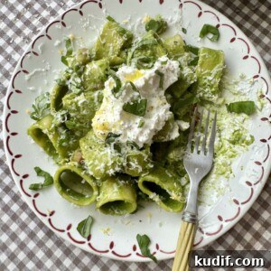 Creamy Spinach & Herb Pasta in Green Sauce 16 pasta in green sauce on a plate topped with cheese