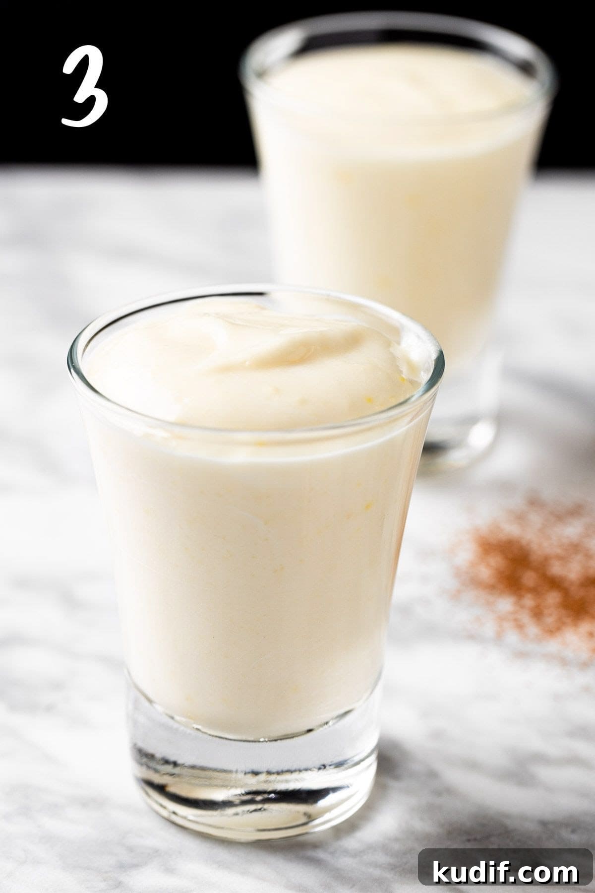 Creamy Vanilla Pudding Shots Recipe for Parties 6 Dividing the vanilla pudding into shot glasses.