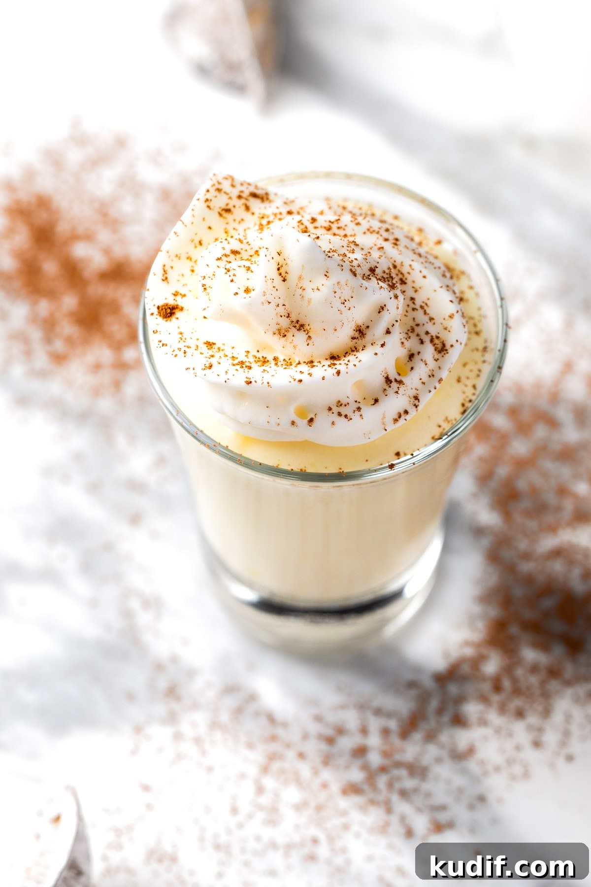 Creamy Vanilla Pudding Shots Recipe for Parties 7 A vodka vanilla pudding shot topped with whipped cream and a sprinkle of cocoa powder.