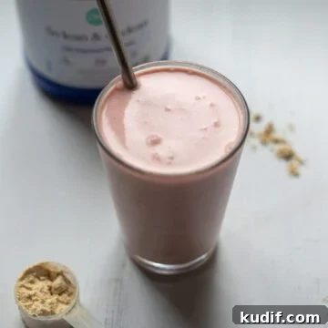 Vegan Strawberries and Cream Protein Breakfast Smoothie 6 45 degree angle looking into a glass full of pink strawberries and cream smoothie